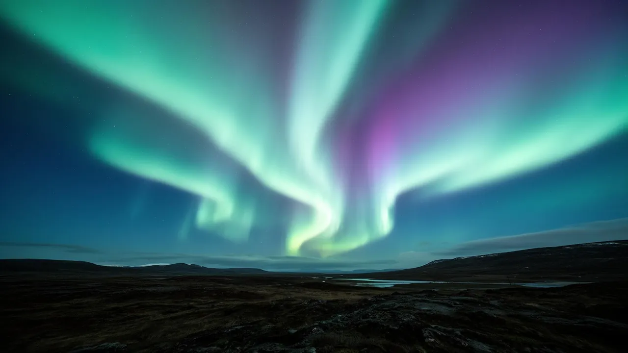 Aurora borealis ribbons of light over a dark landscape